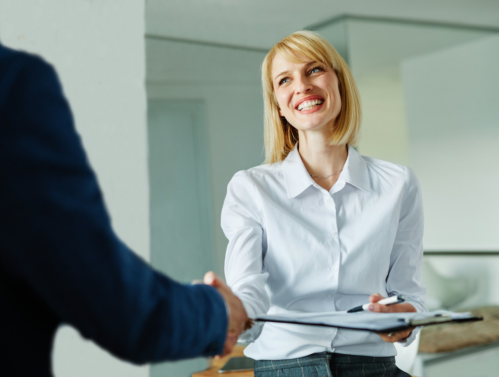 Two professionals shaking hands in an office
